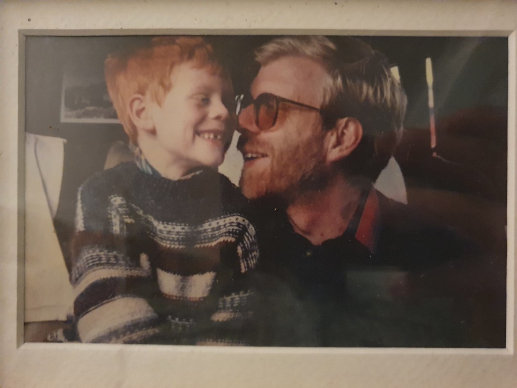 A picture of dad and I smiling and looking into each others eyes when I was a toddler